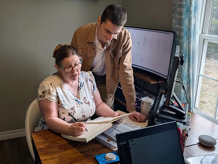 A Nova Scotia small business team gathered together in their workspace.